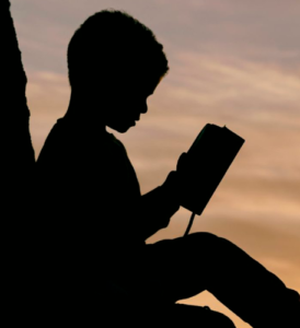 Sitting child reading a book